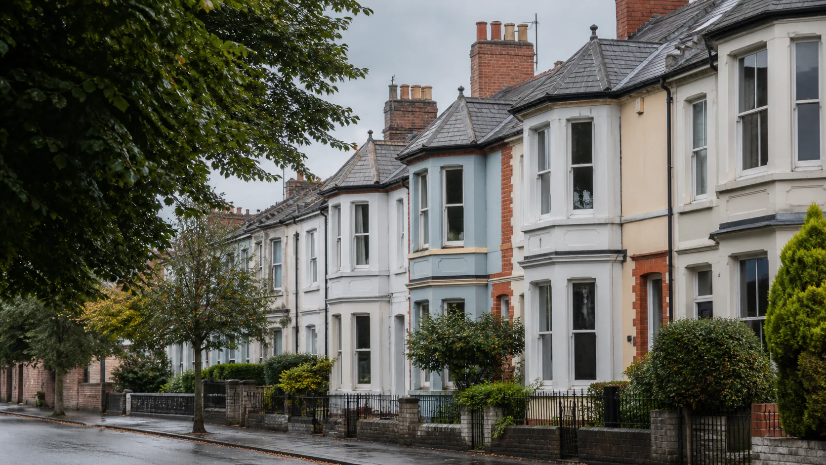 A tree-lined Cardiff street of well-maintained terraced houses with bay windows and Welsh slate roofs